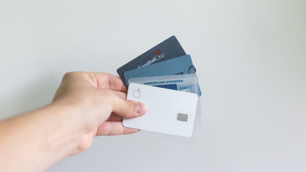 Person holding several credit cards