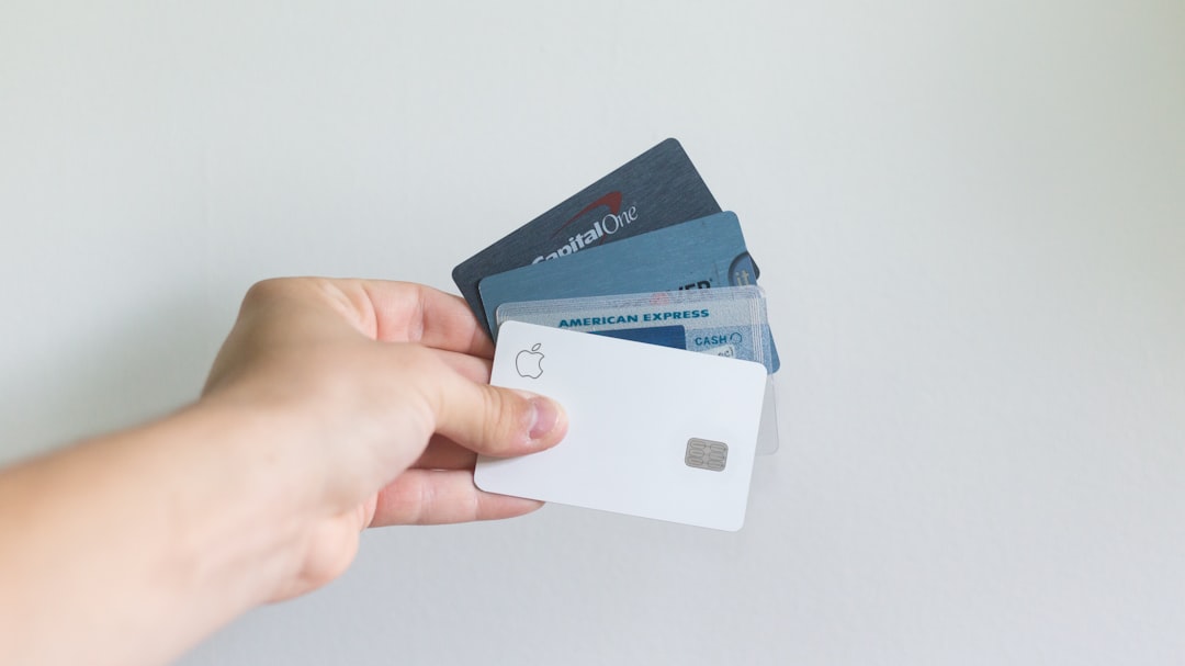 Person holding several credit cards