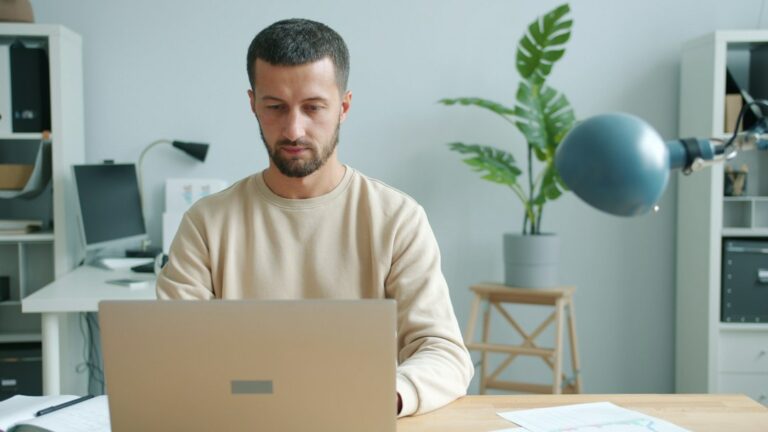 Person working independently on a laptop at a desk