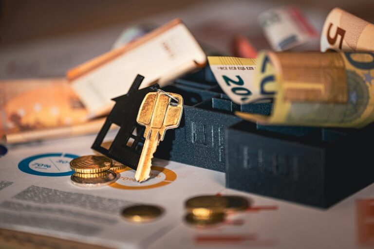 House model, keys and financial documents representing homeownership costs